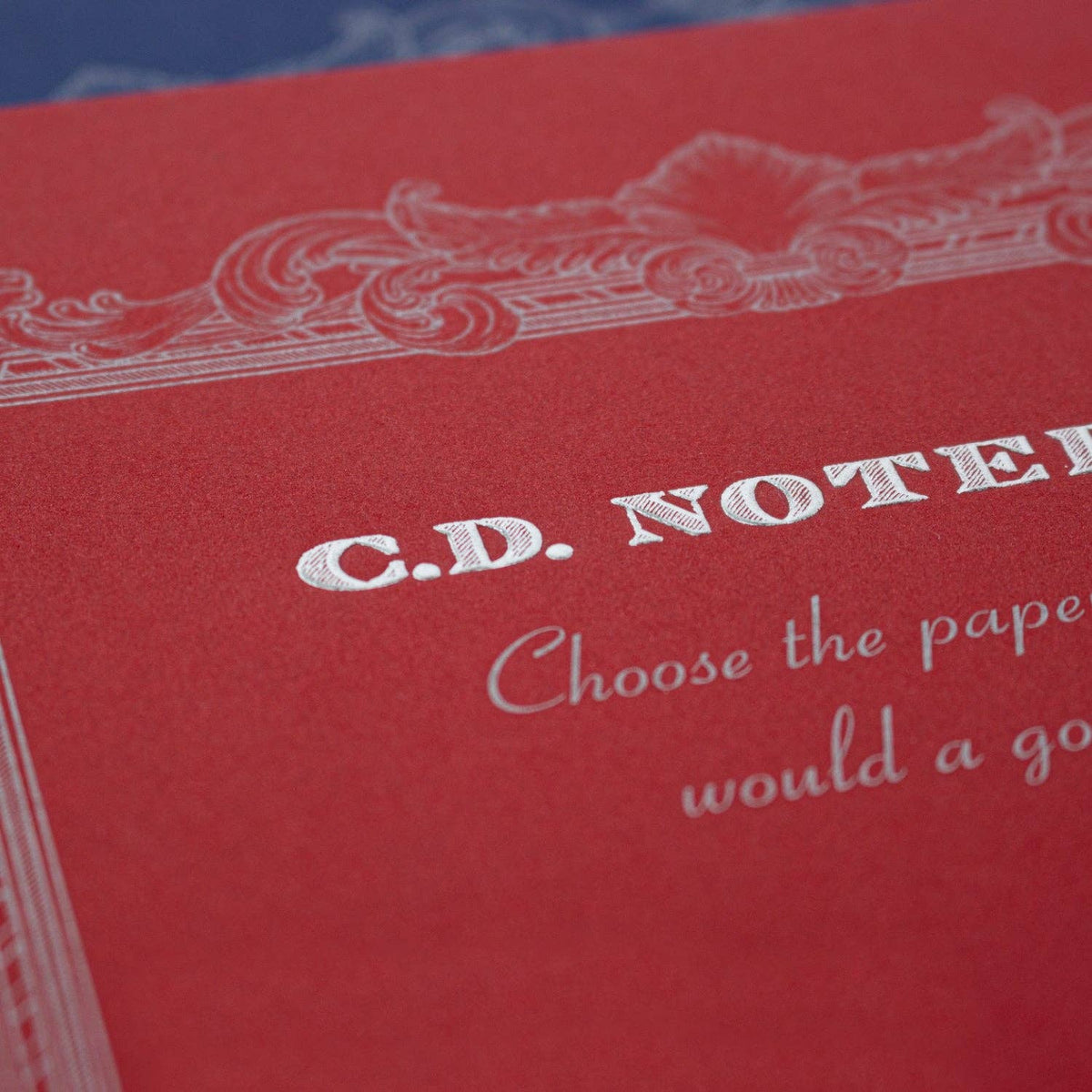 Apica Premium A5 notebook in red with grid pages, cover lettering shown against a blue background